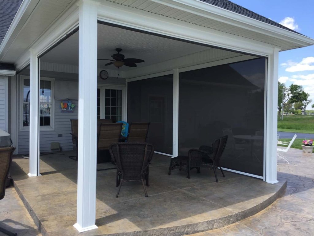 Covered outdoor patio with screen protecting one side